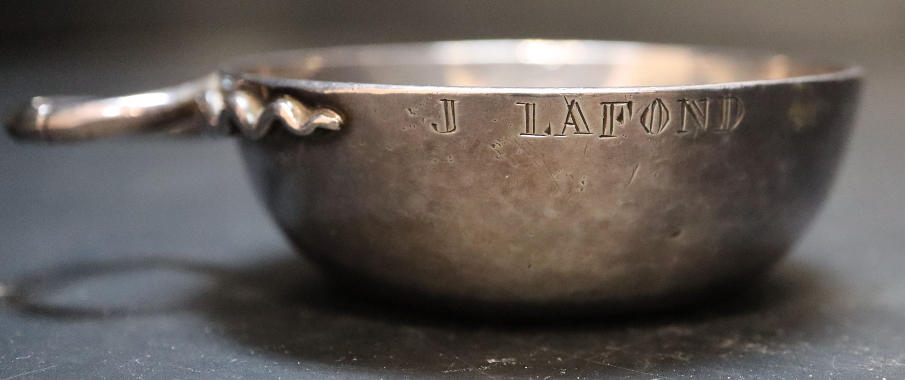 A 19th century French white metal wine taster, diameter 7.6cm, 3.5oz.